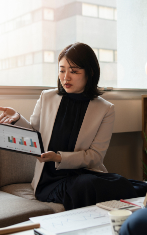 young woman presenting bar graphs on tablet